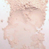 Close-up of soft matte pink vegan eyeshadow in compact with quartz-infused mineral makeup and silky texture