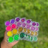 Vibrant glitter eye shadow palette with multiple shimmer shades in a sleek rectangular compact