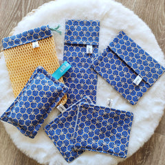 Eco-friendly soap net and washable sponge in sleek travel cases, angled to show texture details