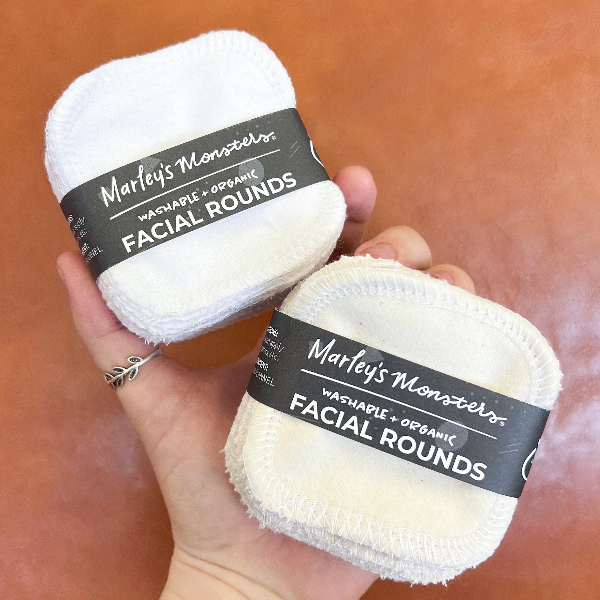Stack of soft white organic cotton facial rounds in a minimalist paper package for gentle skincare routines