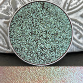 Pressed pan holographic eyeshadow with shifting tea-colored multi-chrome finish in round compact