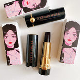 Lipstick, black and gold tube with YINNA BELLE text, open lipstick revealing dark color