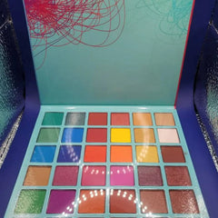 Side view of 36-color eyeshadow palette showing rectangular pans in matte and shimmer finishes arranged in gradient rows