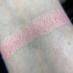 Side view of Petal Soft Eye Shadow compact showing satin pink case and pressed powder texture