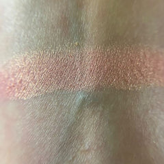 Close-up of fingertips applying Petal Soft Eye Shadow in a soft pink shade to eyelid