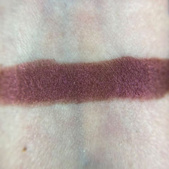 Side view of Invoke Thee Eye Shadow palette showcasing shimmering bronze and plum shades in sleek black compact