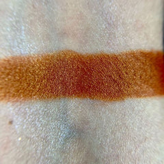 Side view of Mary Eye Shadow Palette showcasing shimmering bronze and mauve shades in sleek black compact