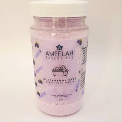 Bubble bath powder in a clear plastic jar with white lid, pink powder, and Ameelah Essentials label with blackberry design