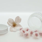 Lip balm refills, pink and clear plastic, with flower and container visible