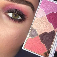 Eyeshadow palette with pink, purple, and neutral shades, patterned design, used for eye makeup