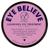 Eye balm, round container with pink label, black rim, and EYE BELIEVE text