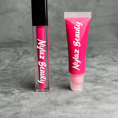 Lip gloss tubes with pink gloss and Nylaz Beauty branding on a grey surface.