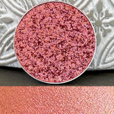Eyeshadow pan with multi-chrome pink color, metallic finish, and silver rim detail