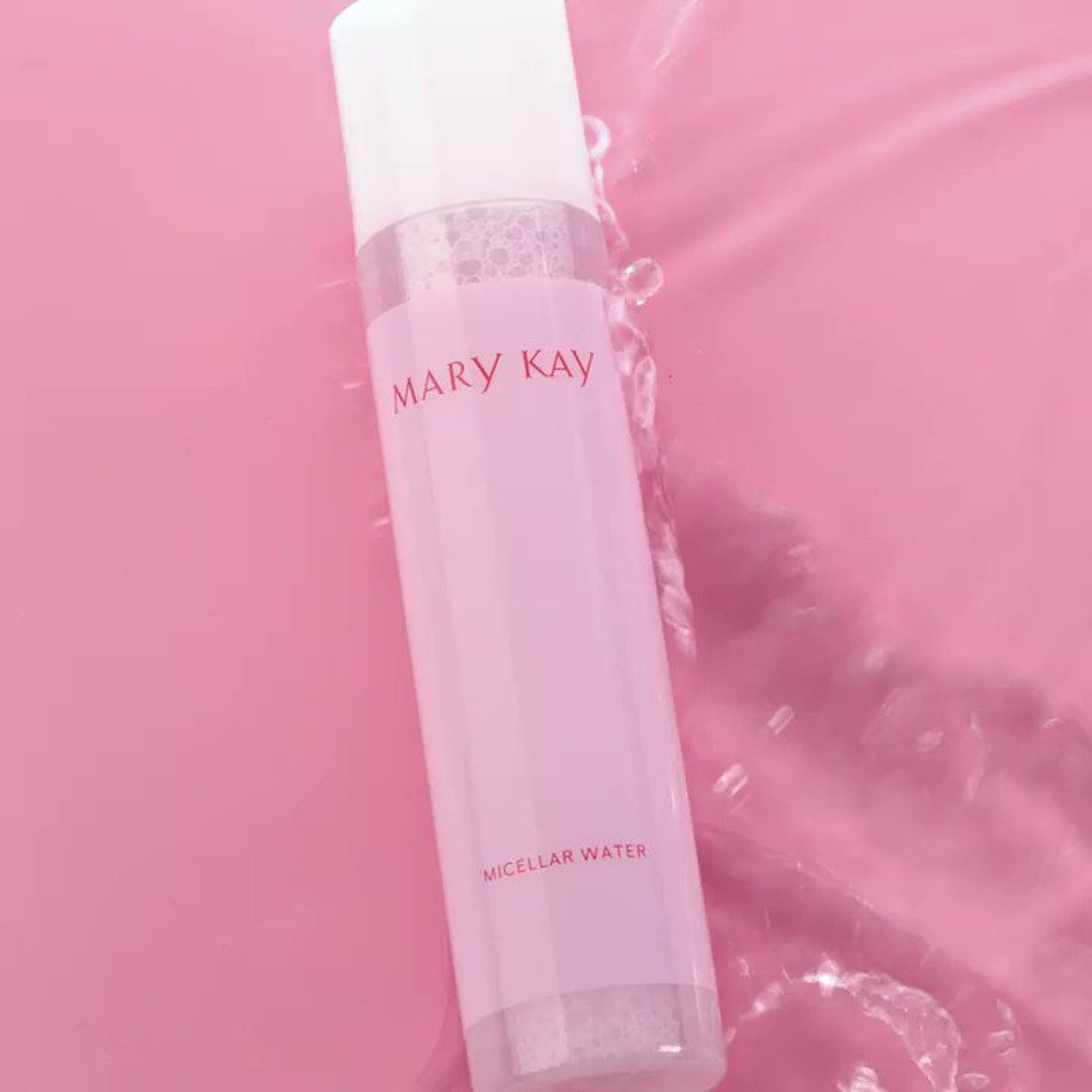 Micellar water bottle, pink and white plastic, Mary Kay branding, in water