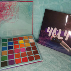 Close-up of 36 vibrant eyeshadow shades in matte, shimmer, and metallic finishes arranged in rectangular pans