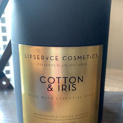 Candle with black and gold label, featuring "Cotton & Iris" text, by Lipservce Cosmetics