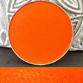 Eyeshadow pan, bright orange matte, metallic silver rim, circular shape