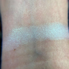 Side view of Stardust Eye Shadow Palette showcasing shimmering cosmic shades in compact case