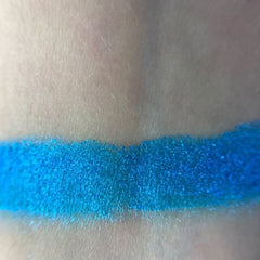 Woman applying soft taupe Luna Eye Shadow to eyelid with fluffy brush for a blended look