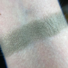 Side view of Betelgeuse eye shadow pot showing vibrant orange-red pigment with smooth satin finish