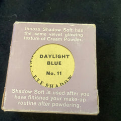 Eye shadow compact with yellow and purple packaging, Innoza brand name visible, "Daylight Blue" color name