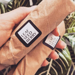 Golden vanilla serum dispensed onto fingertips from amber glass dropper bottle