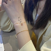 Set of three delicate cat-line temporary tattoos in varying sizes, presented on minimalist skincare packaging