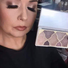 Eyeshadow palette with geometric pattern, neutral colors, and white compact held near face