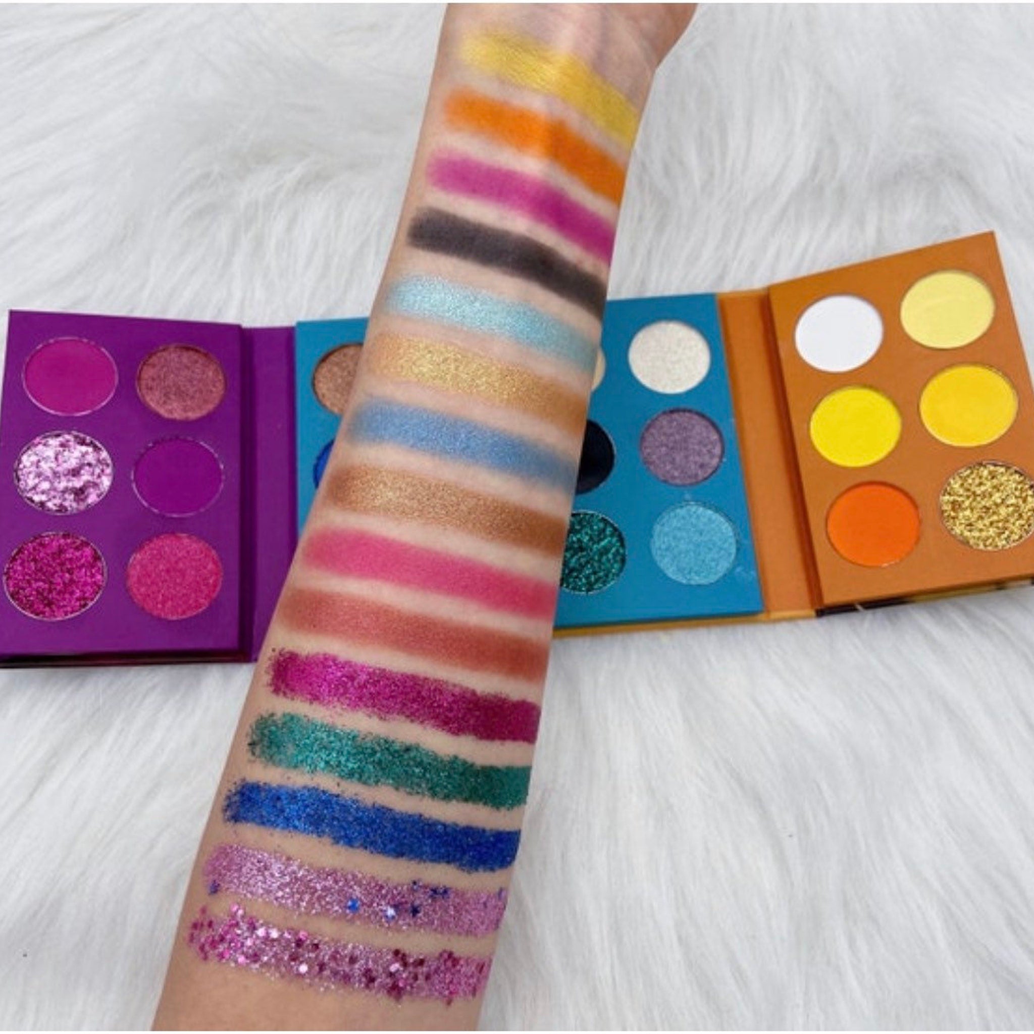 Front view of Face Me Eye Shadow Palette showcasing 12 vibrant matte and shimmer shades in a sleek black compact.