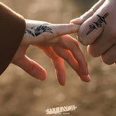 Elegant semi-permanent tattoo ink in sleek black packaging with gold accents, showcasing a luxurious skincare-inspired design