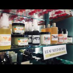 Skincare products in glass bottles and jars with Leaf Seed Berry labels on display