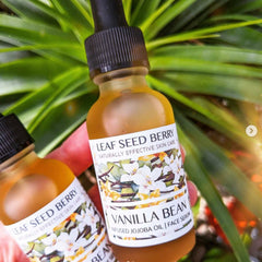 Side view of amber glass dropper bottle with organic vanilla serum, showcasing jojoba oil texture and minimalist label design