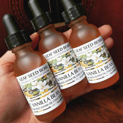 Close-up of golden vanilla serum with jojoba oil in amber glass dropper bottle, showcasing rich texture