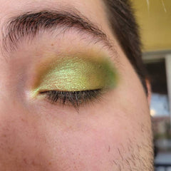 Side view of six green eyeshadow pans in earthy herb-inspired shades with matte and shimmer finishes