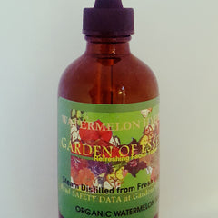 Facial toner bottle, brown glass bottle with black cap, green label with Garden of Essences text