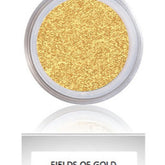 Eyeshadow with gold shimmery powder in clear container