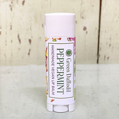 Lip balm tube with white cap, floral pattern, and "Green Daffodil" text label