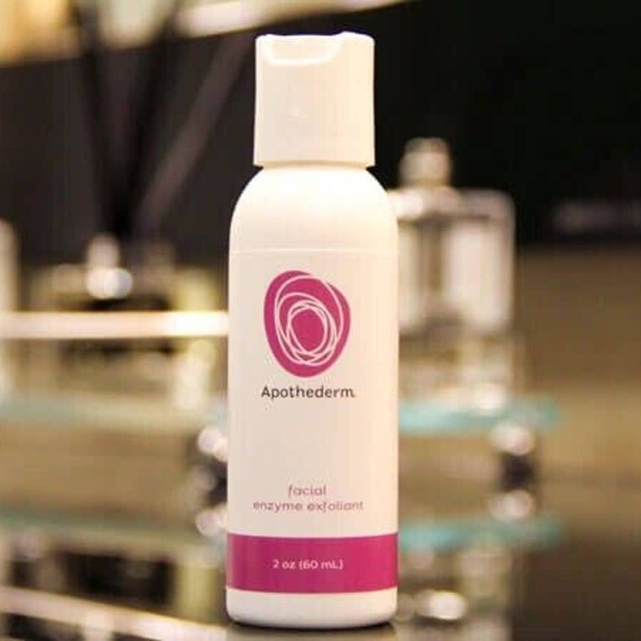 Facial Cleanser bottle, white with pink label, Apothederm branding visible