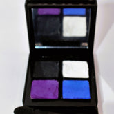 Eyeshadow palette with black, purple, white, and blue colors in a compact case