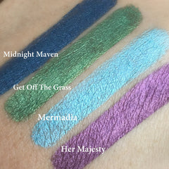 Eyeshadow swatches, green, blue, and purple metallic shades on skin, GET OFF the GRASS text visible