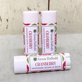 Lip balm tubes, white with red and green pattern, Green Daffodil branding visible