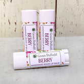 Lip balm tubes, white plastic, floral label, Green Daffodil Berry flavor visible
