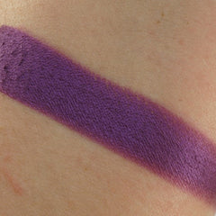 Purple swatch on skin, showing color and texture of product on arm