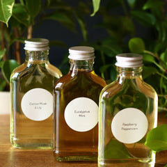 Bottles with clear glass, silver cap, and white labels with text