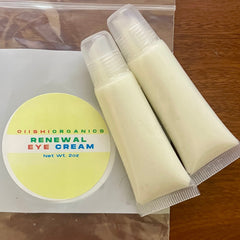 Eye cream tubes with white cream, clear plastic caps, and OIIISHIORGANICS label on yellow circle