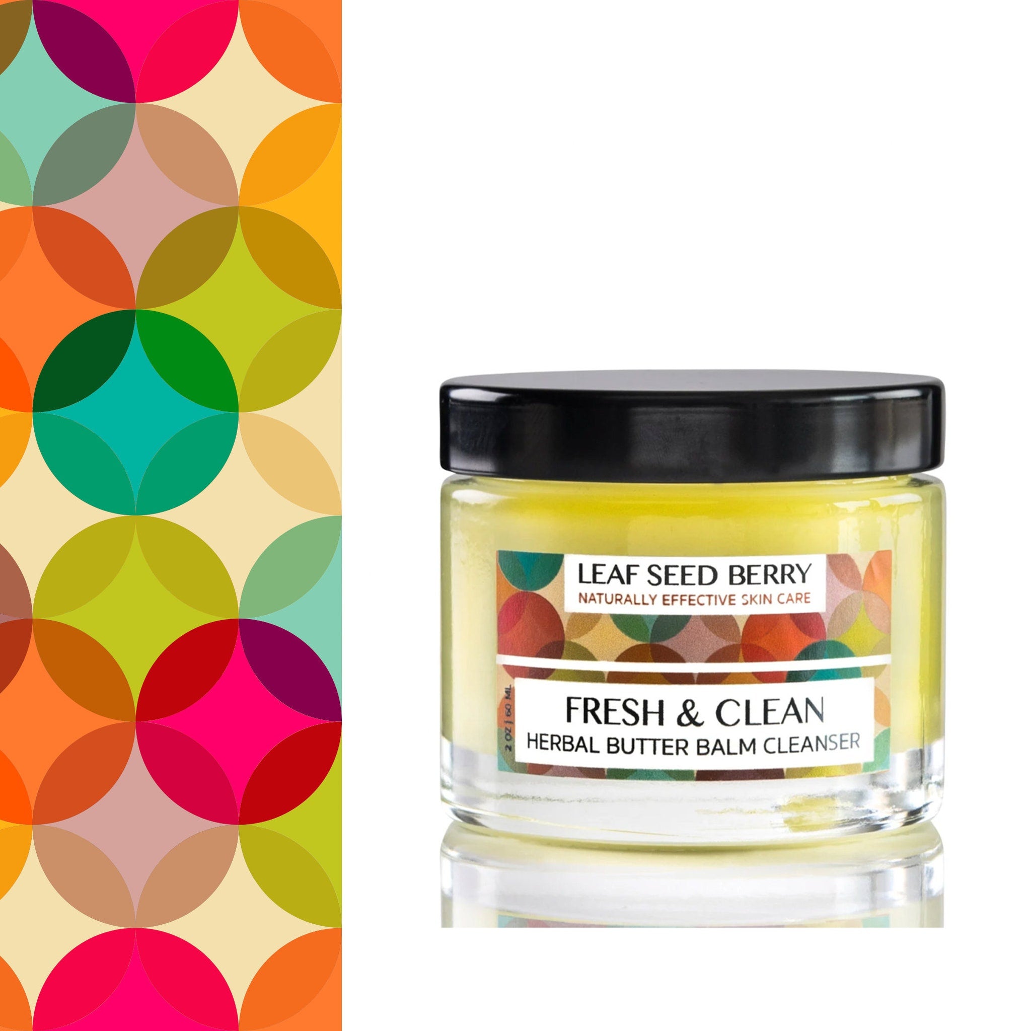 Cleansing balm jar with yellow balm, clear glass, and black lid, Leaf Seed Berry brand
