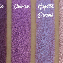Purple eyeshadow swatches with Deliverer and Magenta Dreams text, textured finish on skin