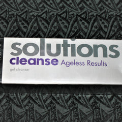 Facial cleanser product with white packaging, purple text, and Avon Solutions brand name visible