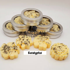 Hand holding a golden shea butter lotion bar against dry skin, demonstrating application