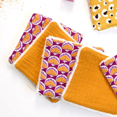 Reusable face cloths in orange, purple floral print, and white trim, soft material
